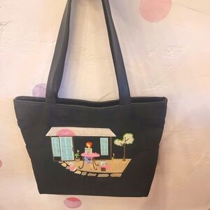 Black should bag with embroidered girl at cafe